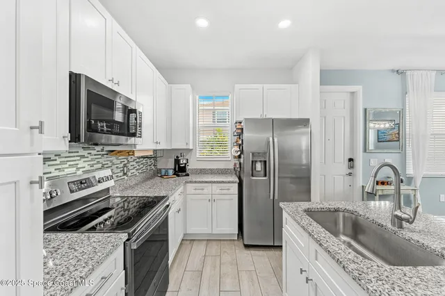 a kitchen with stainless steel appliances a stove microwave and refrigerator