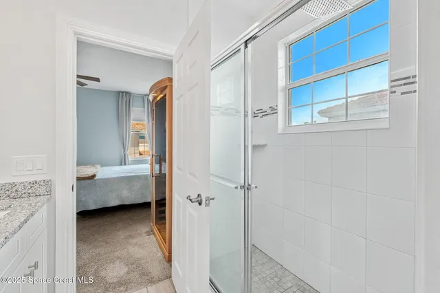 a bedroom with a bed and a painting on the wall