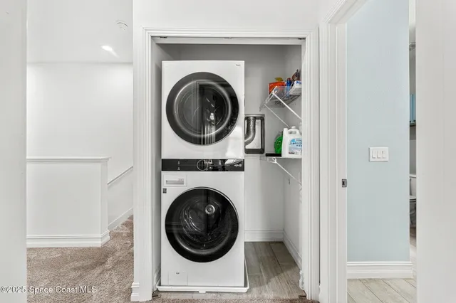 an aerial view of multiple houses with a lake