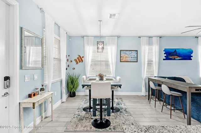 a view of a dining room with furniture and a kitchen