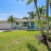 a front view of house with yard and outdoor seating