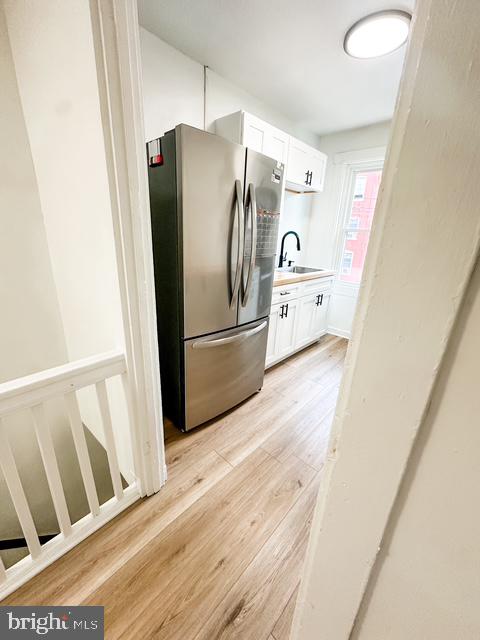 a view of a refrigerator in kitchen and wooden floor