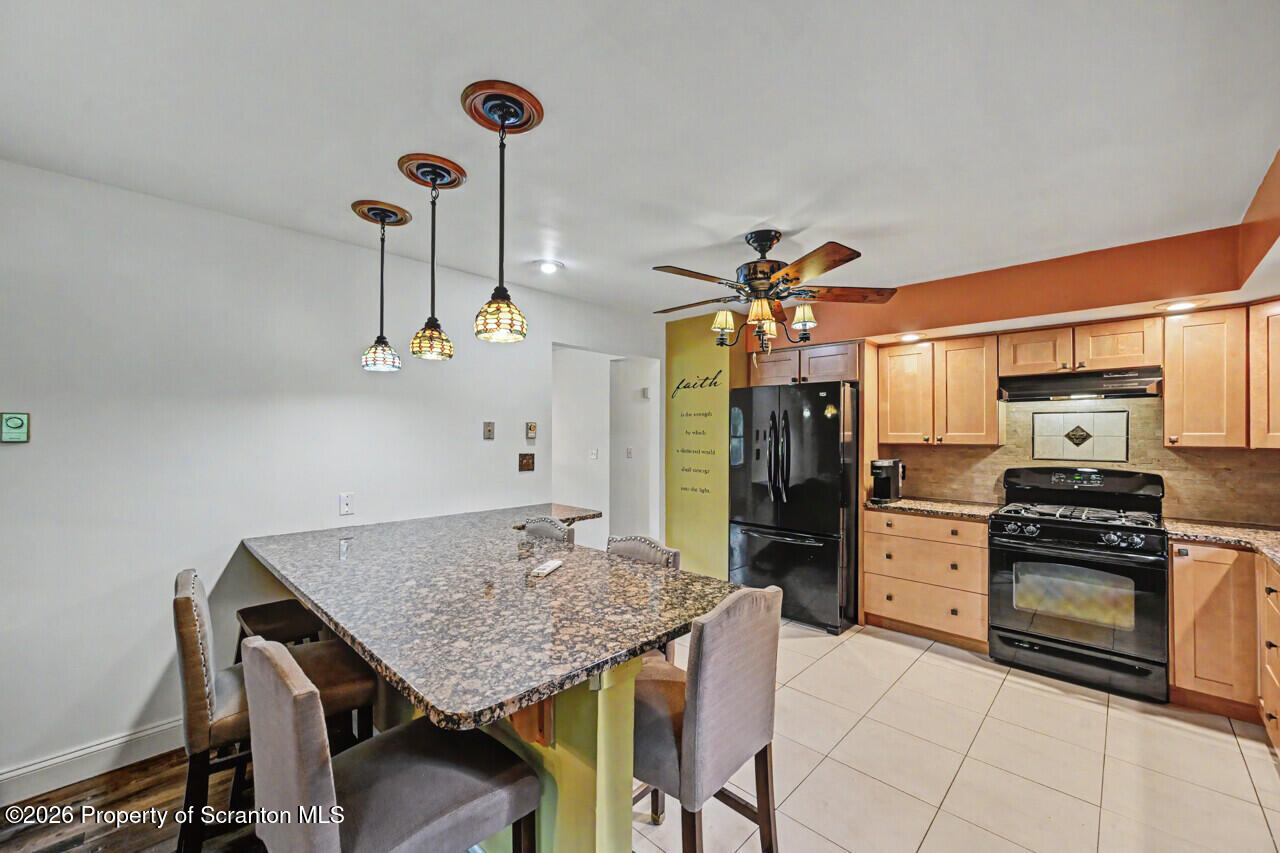 211 Buckingham Street Moscow, PA 18444 - Photo 24 of 83 a kitchen with stainless steel appliances granite countertop a stove refrigerator and cabinets
