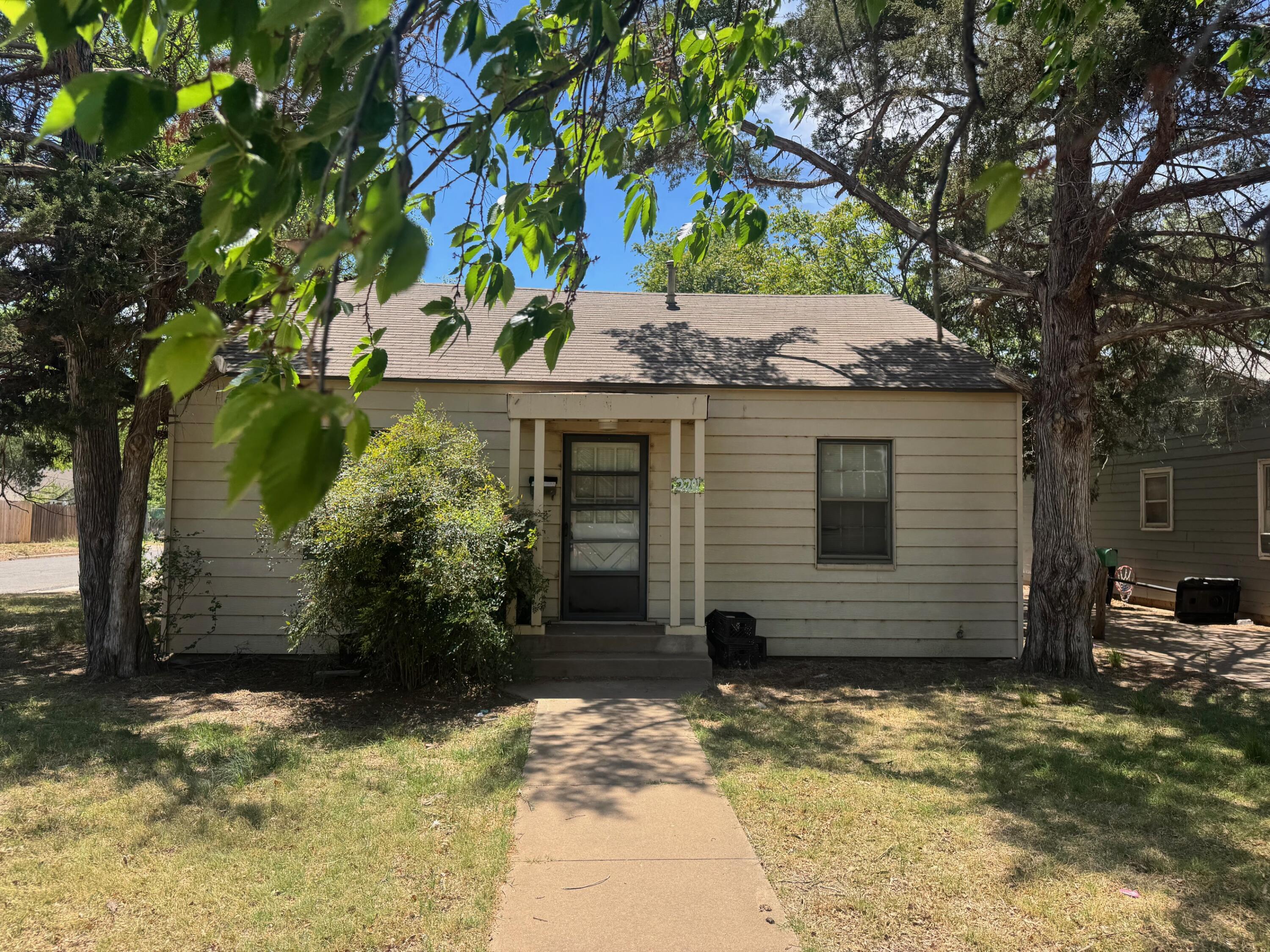 a view of a house with a tree