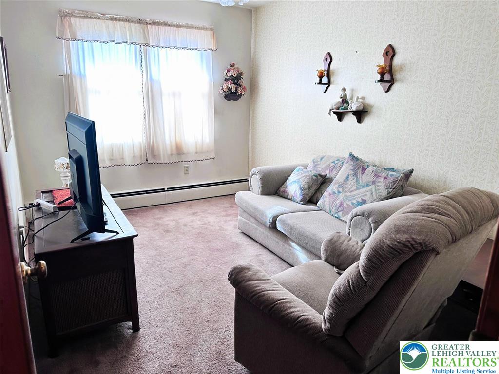 127 South 7th Street Coplay, PA 18037 - Photo 13 of 21 a living room with furniture a window and a flat screen tv