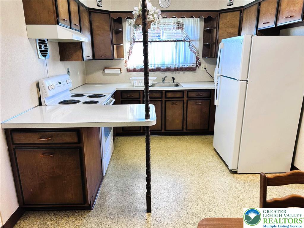 127 South 7th Street Coplay, PA 18037 - Photo 4 of 21 a kitchen with a sink cabinets and a refrigerator