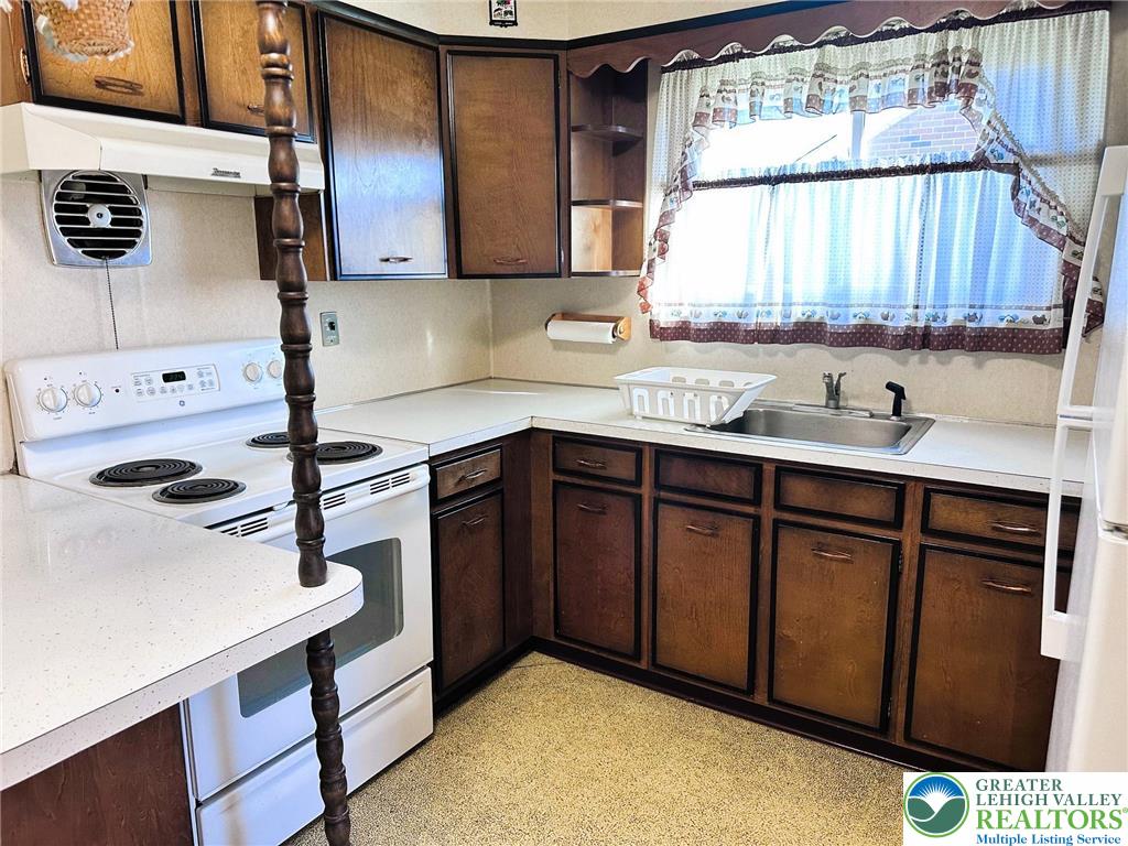 127 South 7th Street Coplay, PA 18037 - Photo 5 of 21 a kitchen with kitchen island a sink a stove and a window