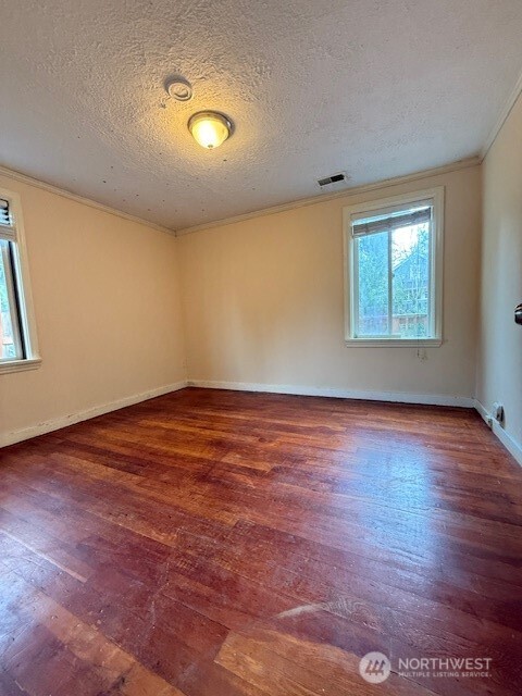 12018 Sand Point Way Northeast Seattle, WA 98125 - Photo 6 of 14 an empty room with wooden floor and windows