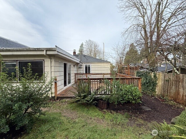 12018 Sand Point Way Northeast Seattle, WA 98125 - Photo 10 of 14 a view of a house with a yard and plants
