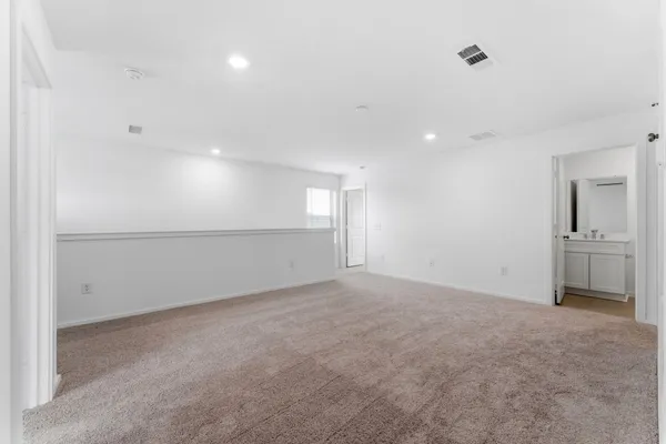 a view of an empty room with a kitchen