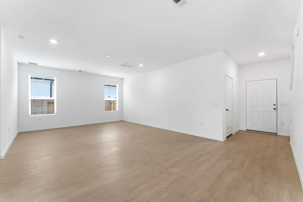 an empty room with windows and closet