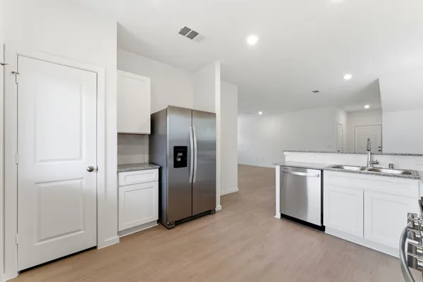 a kitchen with stainless steel appliances a refrigerator and a sink