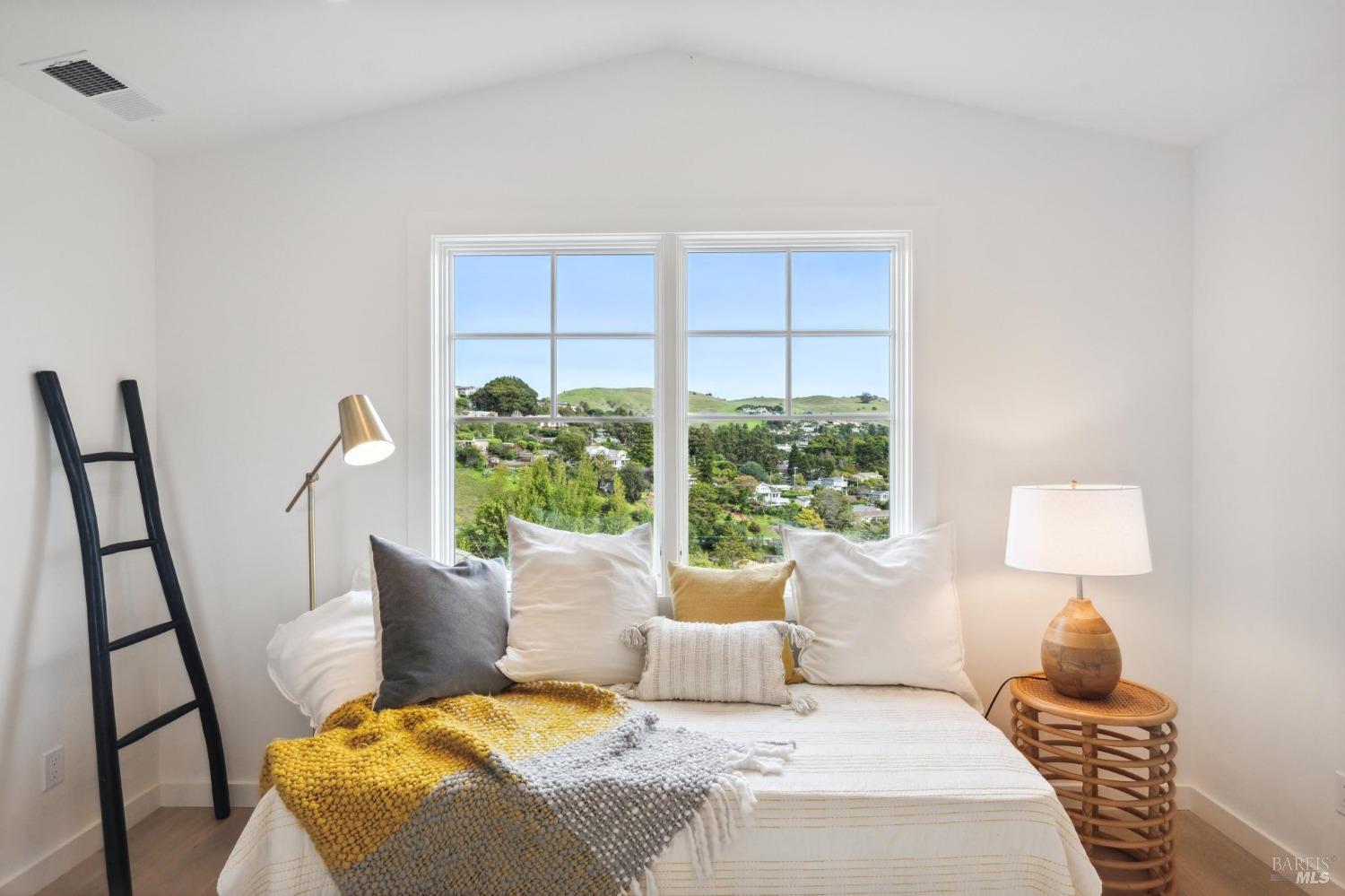 144 Richardson Drive Mill Valley, CA 94941 - Photo 30 of 43 a bedroom with a bed a lamp and a large window