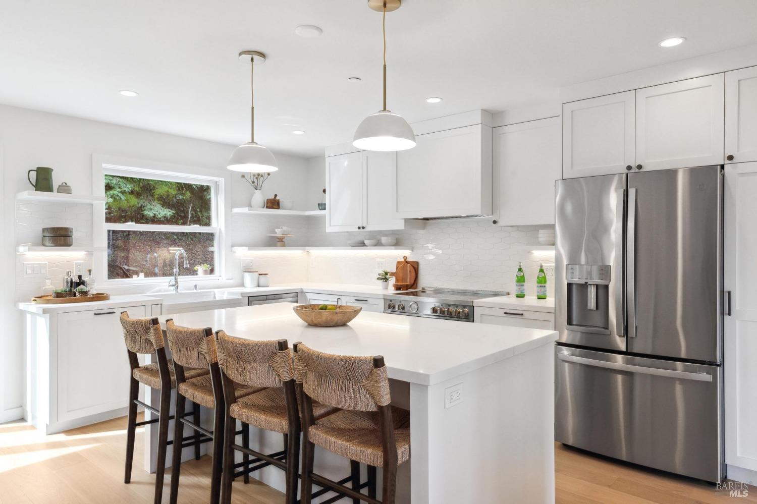 144 Richardson Drive Mill Valley, CA 94941 - Photo 7 of 43 a kitchen with stainless steel appliances granite countertop a refrigerator a sink a stove a dining table and chairs