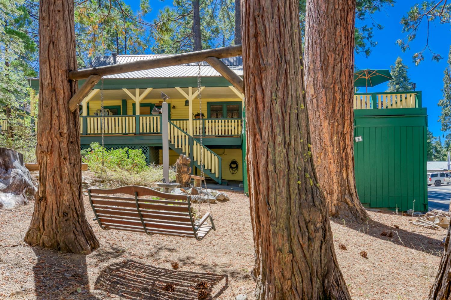 42025 Tollhouse Road Shaver Lake, CA 93664 - Photo 12 of 64 a view of a entrance gate of the house and trees