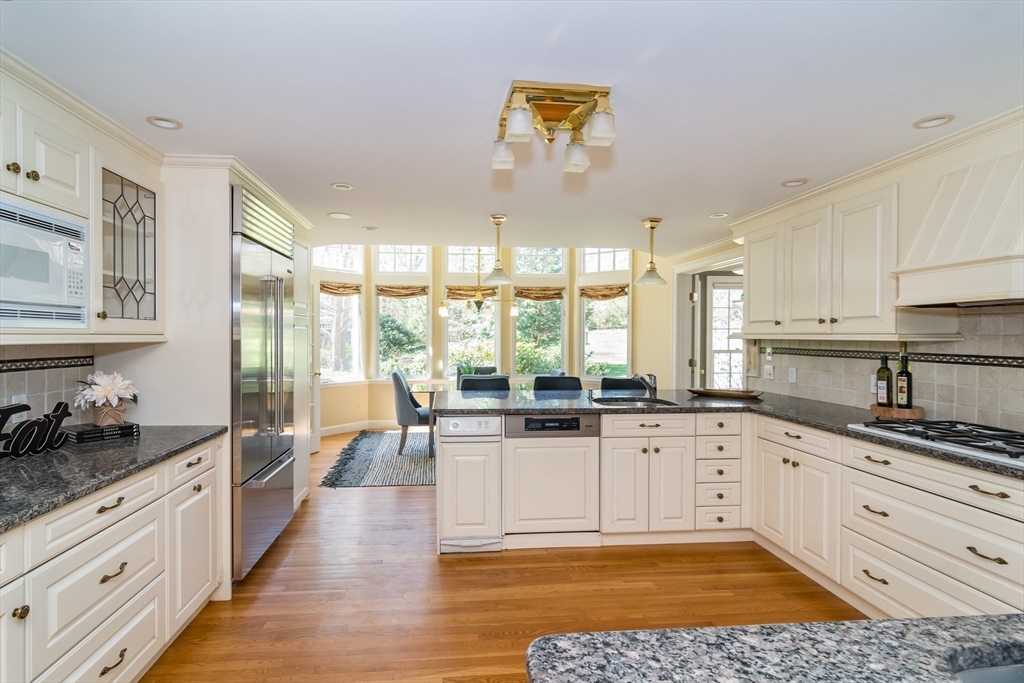 25 Edgewater Drive Needham, MA 02492 - Photo 5 of 25 a kitchen with granite countertop a stove a sink and a refrigerator