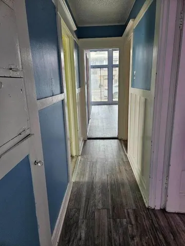 a view of hallway with wooden floor and staircase