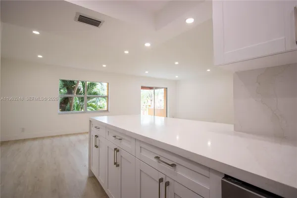 a view of kitchen with center island and wooden floor