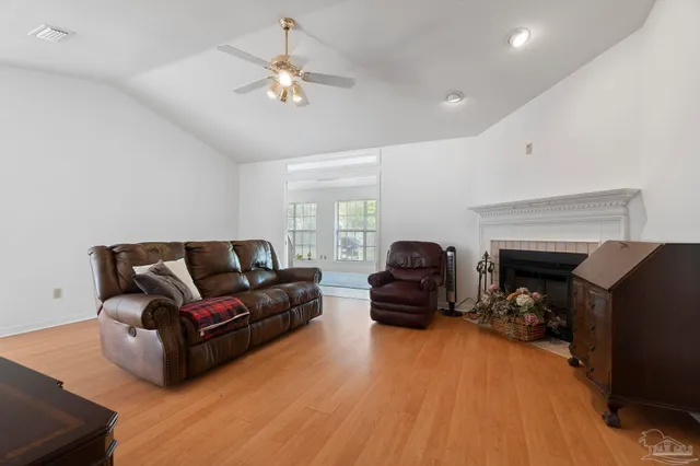 a living room with furniture and a lamp