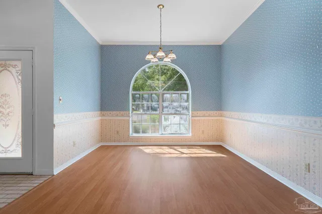 a view of a livingroom with a furniture wooden floor and a chandelier