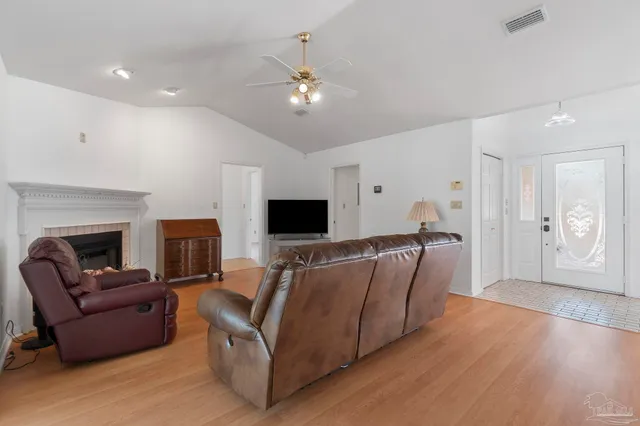 a living room with furniture and a fireplace