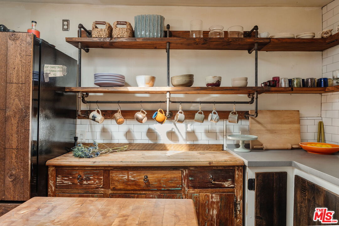 23300 Red Rock Road Topanga, CA 90290 - Photo 13 of 59 a view of a kitchen with stainless steel appliances granite countertop a sink a stove and cabinets