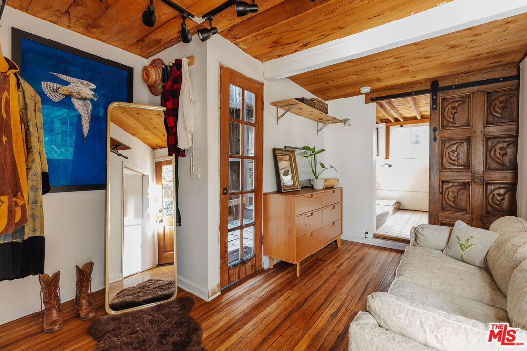 23300 Red Rock Road Topanga, CA 90290 - Photo 15 of 59 a bedroom with furniture and wooden floor