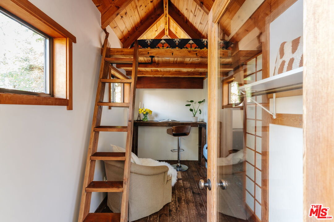 23300 Red Rock Road Topanga, CA 90290 - Photo 27 of 59 a bathroom with a toilet and a shower curtain