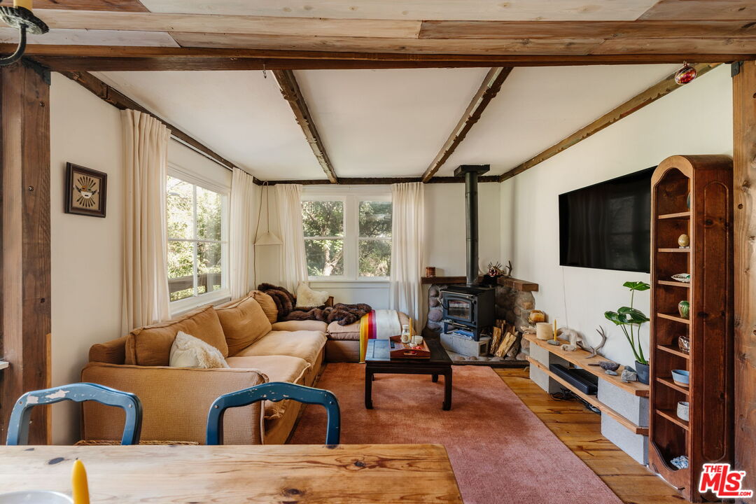 23300 Red Rock Road Topanga, CA 90290 - Photo 3 of 59 a living room with furniture a flat screen tv and a window