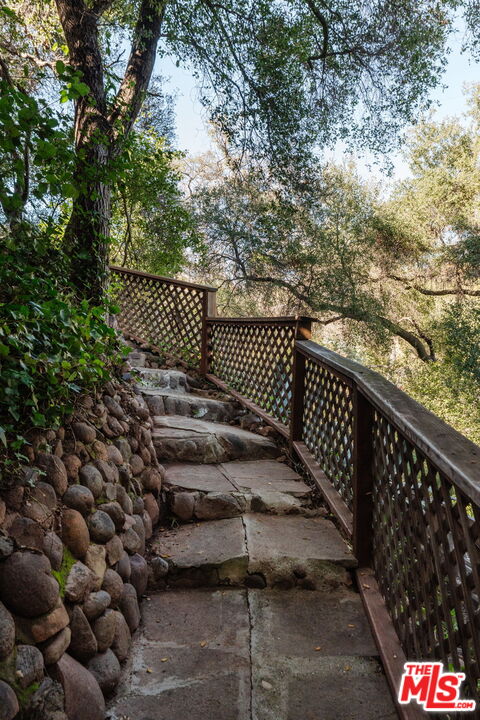 23300 Red Rock Road Topanga, CA 90290 - Photo 33 of 59 a view of a black gate with wooden fence