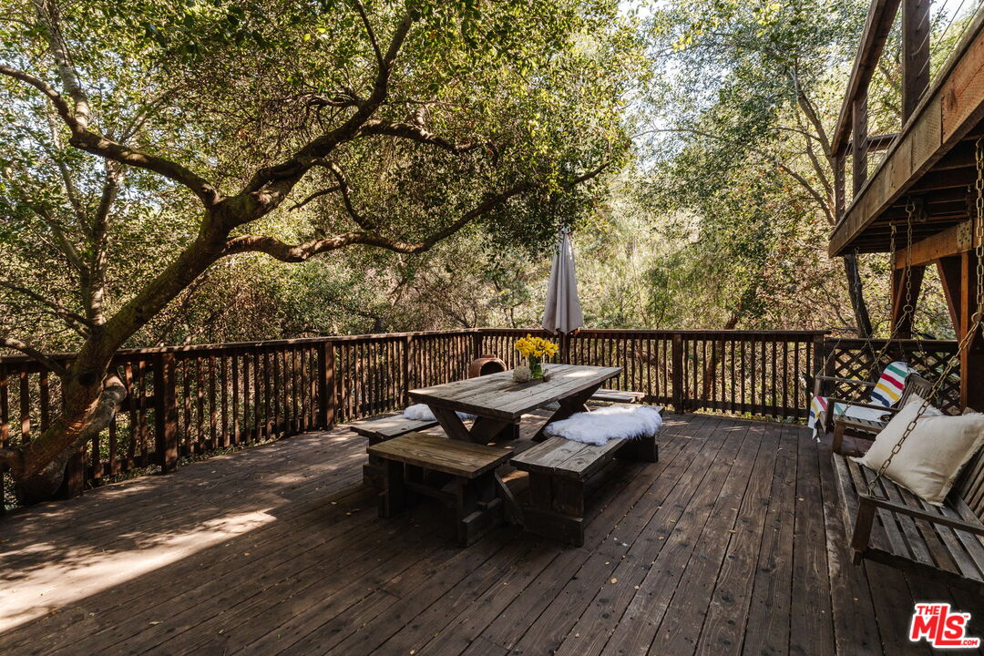 23300 Red Rock Road Topanga, CA 90290 - Photo 34 of 59 a roof deck with wooden floor and fence