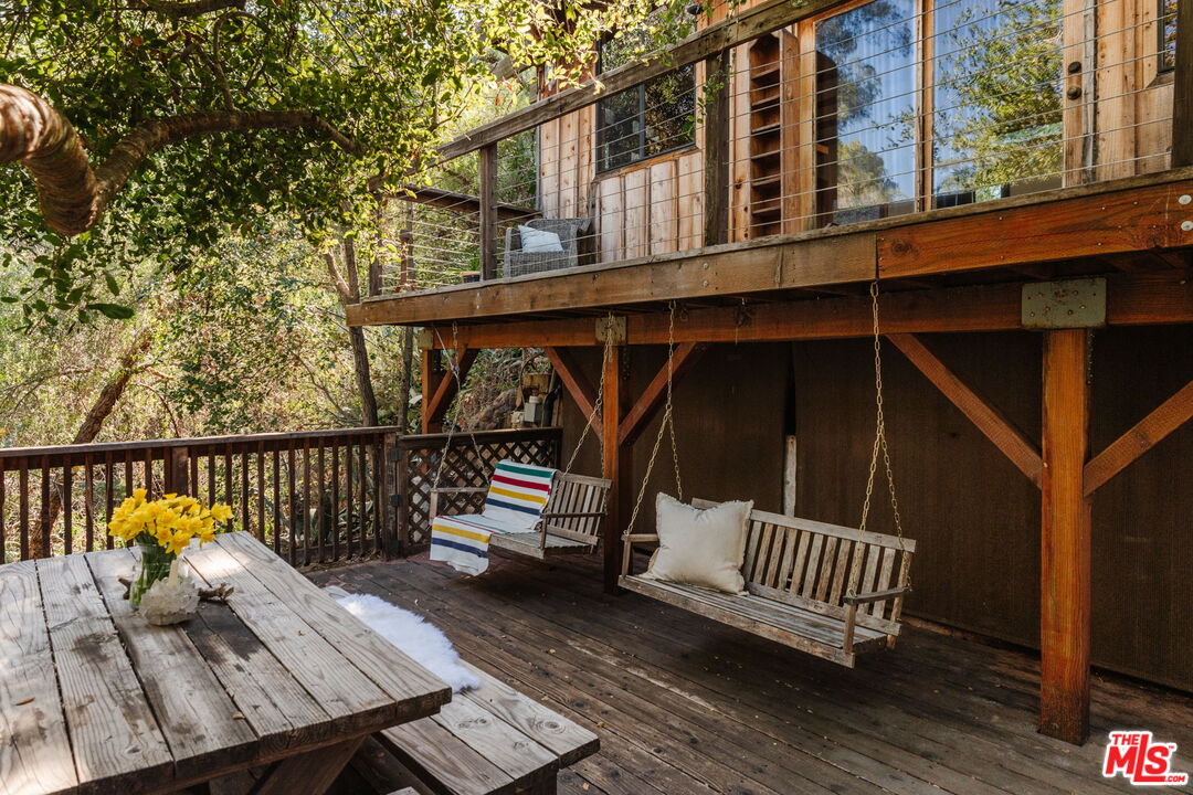23300 Red Rock Road Topanga, CA 90290 - Photo 35 of 59 a view of a roof deck with wooden fence and floor