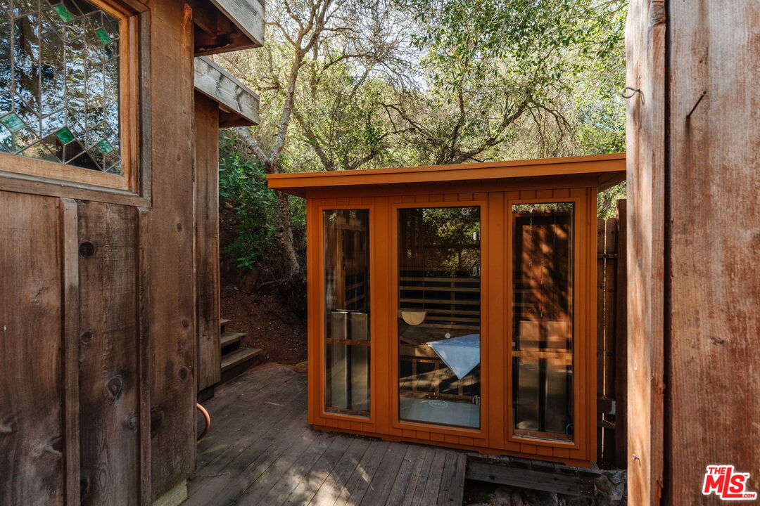 23300 Red Rock Road Topanga, CA 90290 - Photo 39 of 59 a view of a house with a porch and furniture