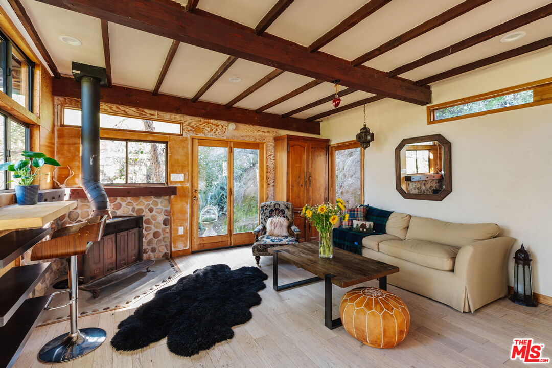 23300 Red Rock Road Topanga, CA 90290 - Photo 40 of 59 a living room with furniture and a floor to ceiling window