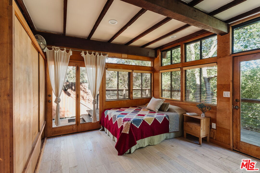 23300 Red Rock Road Topanga, CA 90290 - Photo 42 of 59 a bedroom with bed and a large window