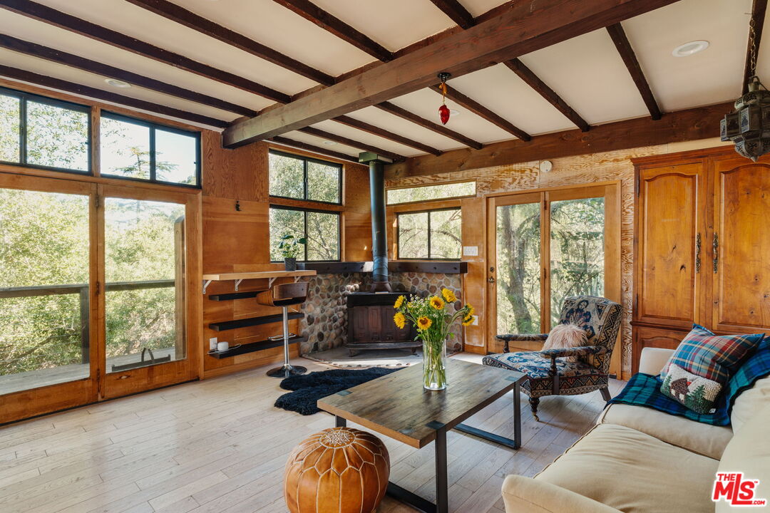23300 Red Rock Road Topanga, CA 90290 - Photo 43 of 59 a living room with furniture and floor to ceiling windows