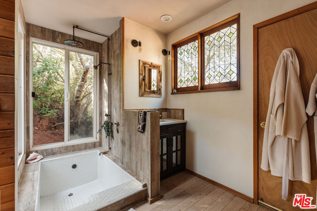 23300 Red Rock Road Topanga, CA 90290 - Photo 44 of 59 a bathroom with a bathtub and a shower