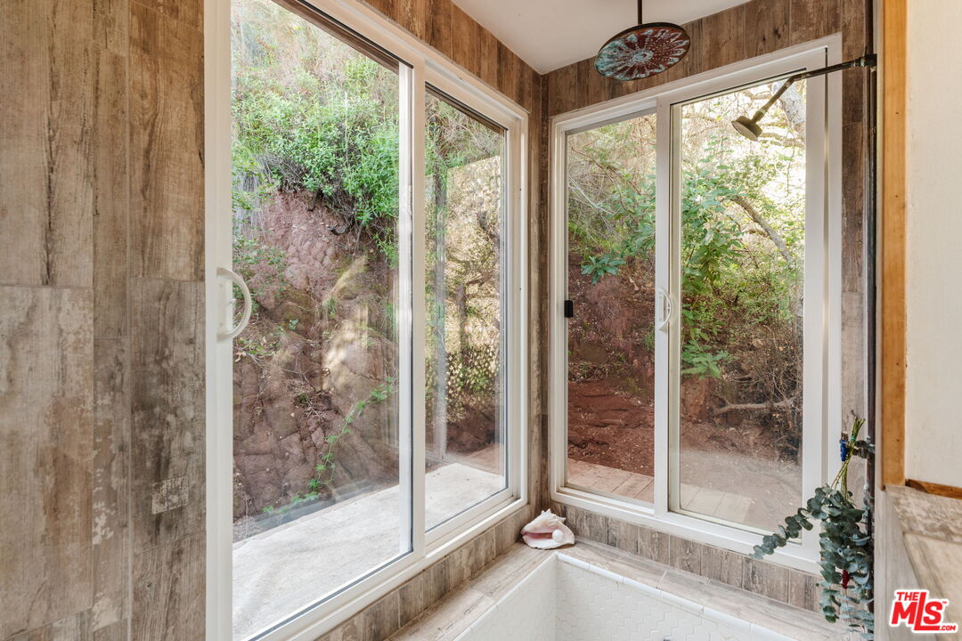 23300 Red Rock Road Topanga, CA 90290 - Photo 46 of 59 a bathroom with a glass door and a glass door