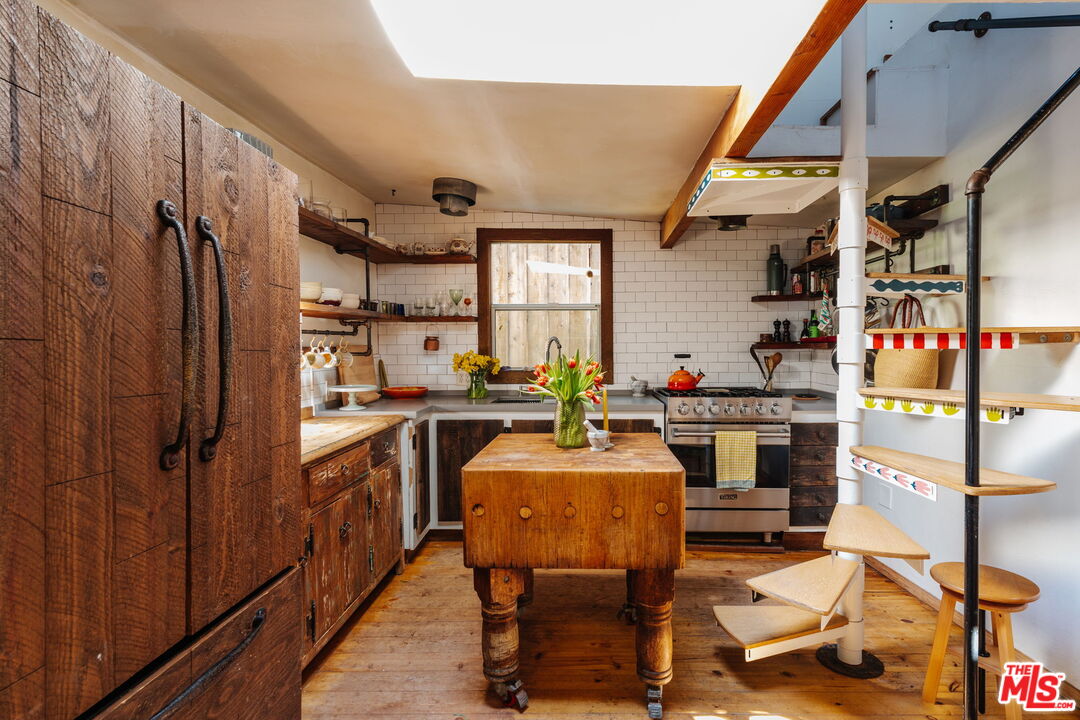 23300 Red Rock Road Topanga, CA 90290 - Photo 5 of 59 a room with stainless steel appliances kitchen island granite countertop furniture and a kitchen view
