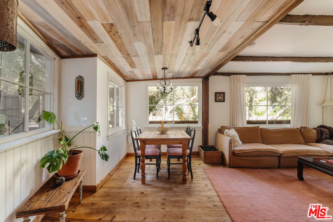 23300 Red Rock Road Topanga, CA 90290 - Photo 10 of 59 a living room with furniture a wooden floor and a large window
