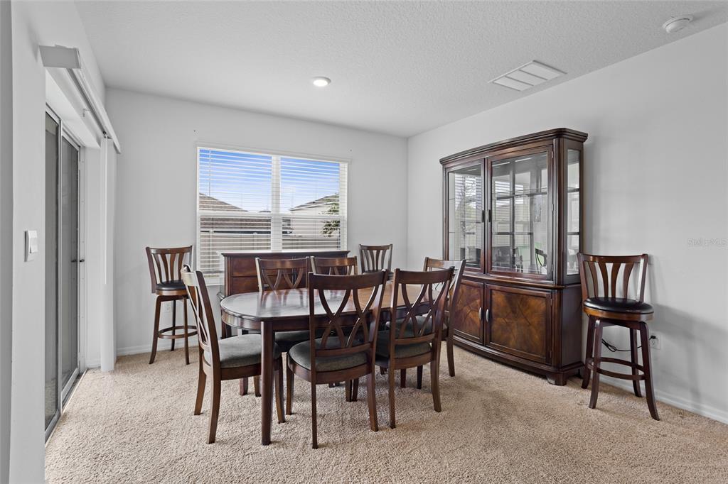2143 Kalin Way Tavares, FL 32778 - Photo 17 of 37 a view of a dining room with furniture and a window