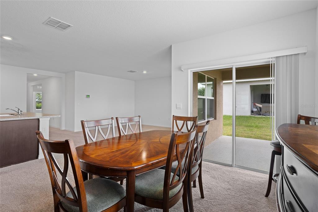 2143 Kalin Way Tavares, FL 32778 - Photo 18 of 37 a view of a dining room with furniture and a window