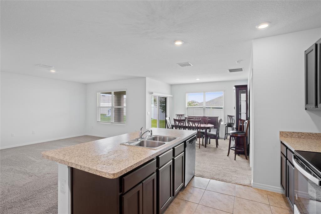 2143 Kalin Way Tavares, FL 32778 - Photo 21 of 37 a open kitchen with stainless steel appliances granite countertop a stove and a sink