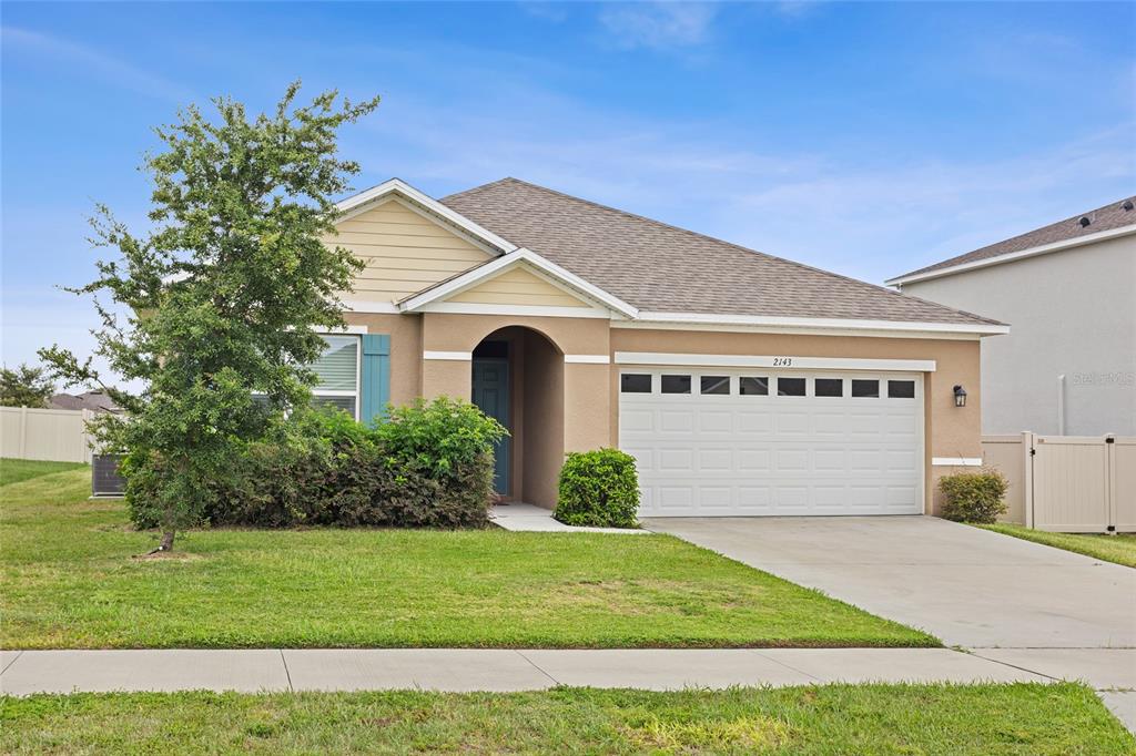 2143 Kalin Way Tavares, FL 32778 - Photo 3 of 37 a front view of a house with a yard and garage