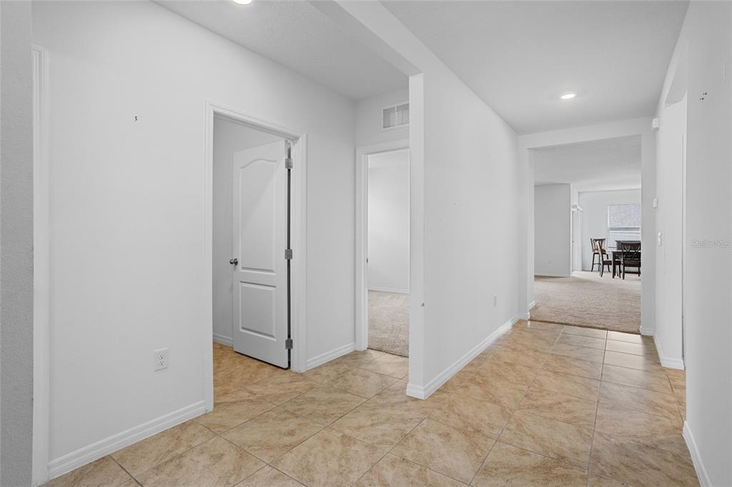 2143 Kalin Way Tavares, FL 32778 - Photo 7 of 37 a view of a hallway with a dining table and chairs