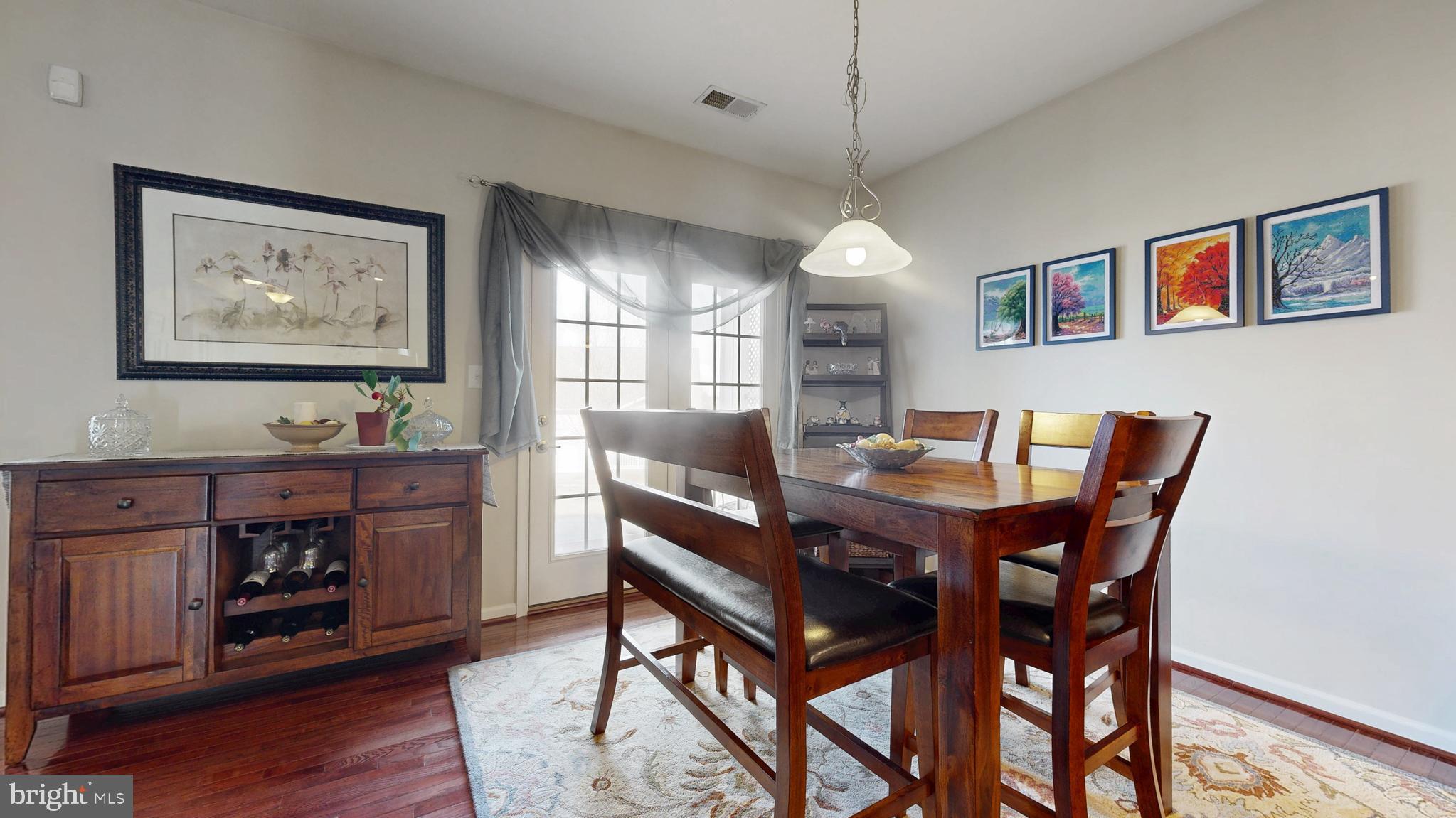 546 Stonehaven Drive Townsend, DE 19734 - Photo 15 of 60 a view of a dining room with furniture window and wooden floor