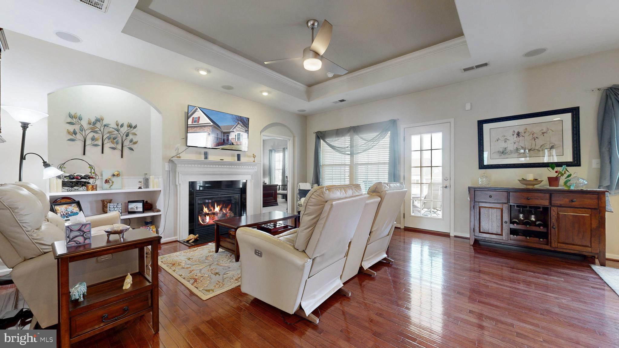 546 Stonehaven Drive Townsend, DE 19734 - Photo 22 of 60 a living room with furniture a fireplace and a flat screen tv