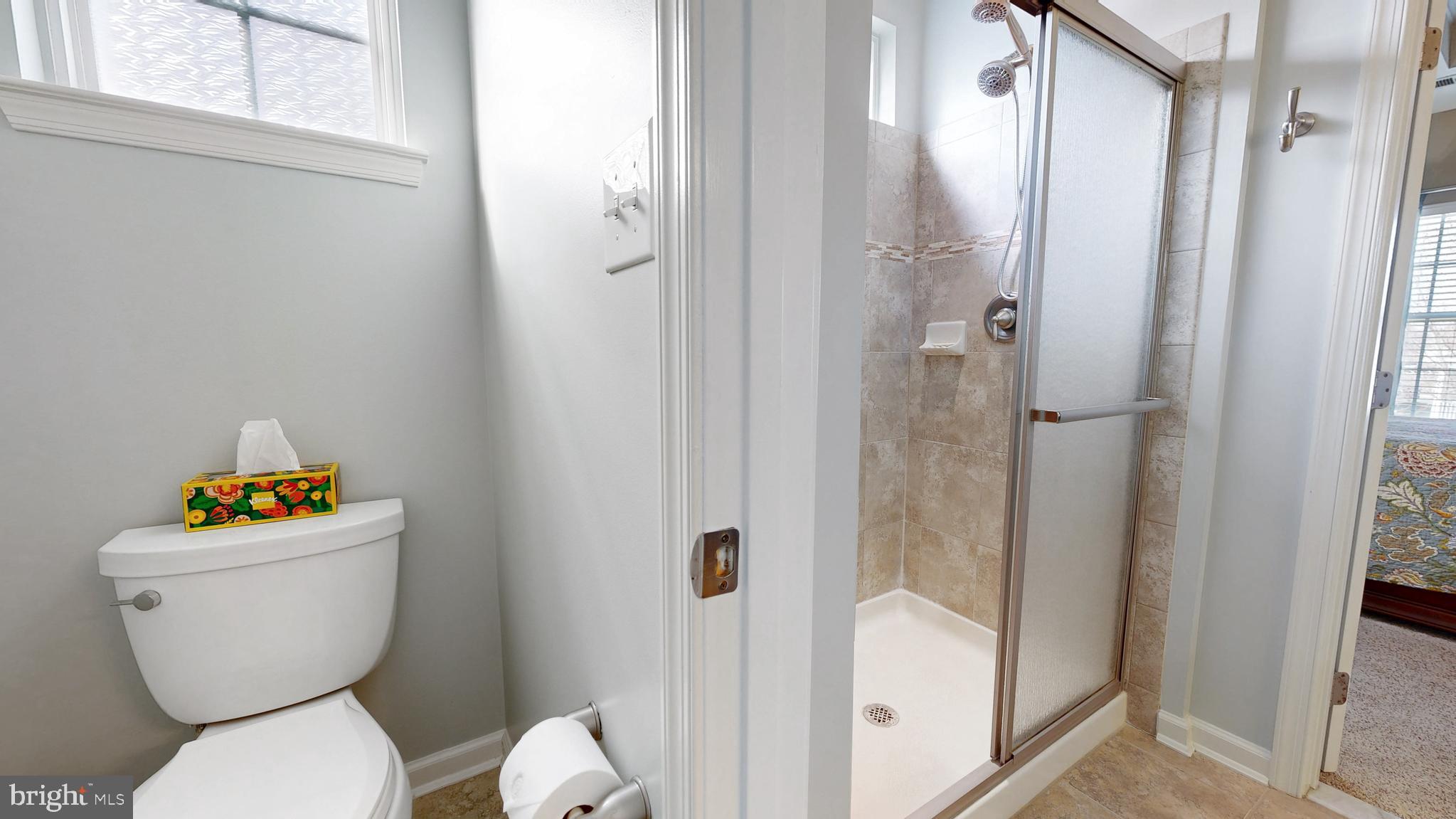 546 Stonehaven Drive Townsend, DE 19734 - Photo 28 of 60 a white toilet sitting next to a bathroom sink