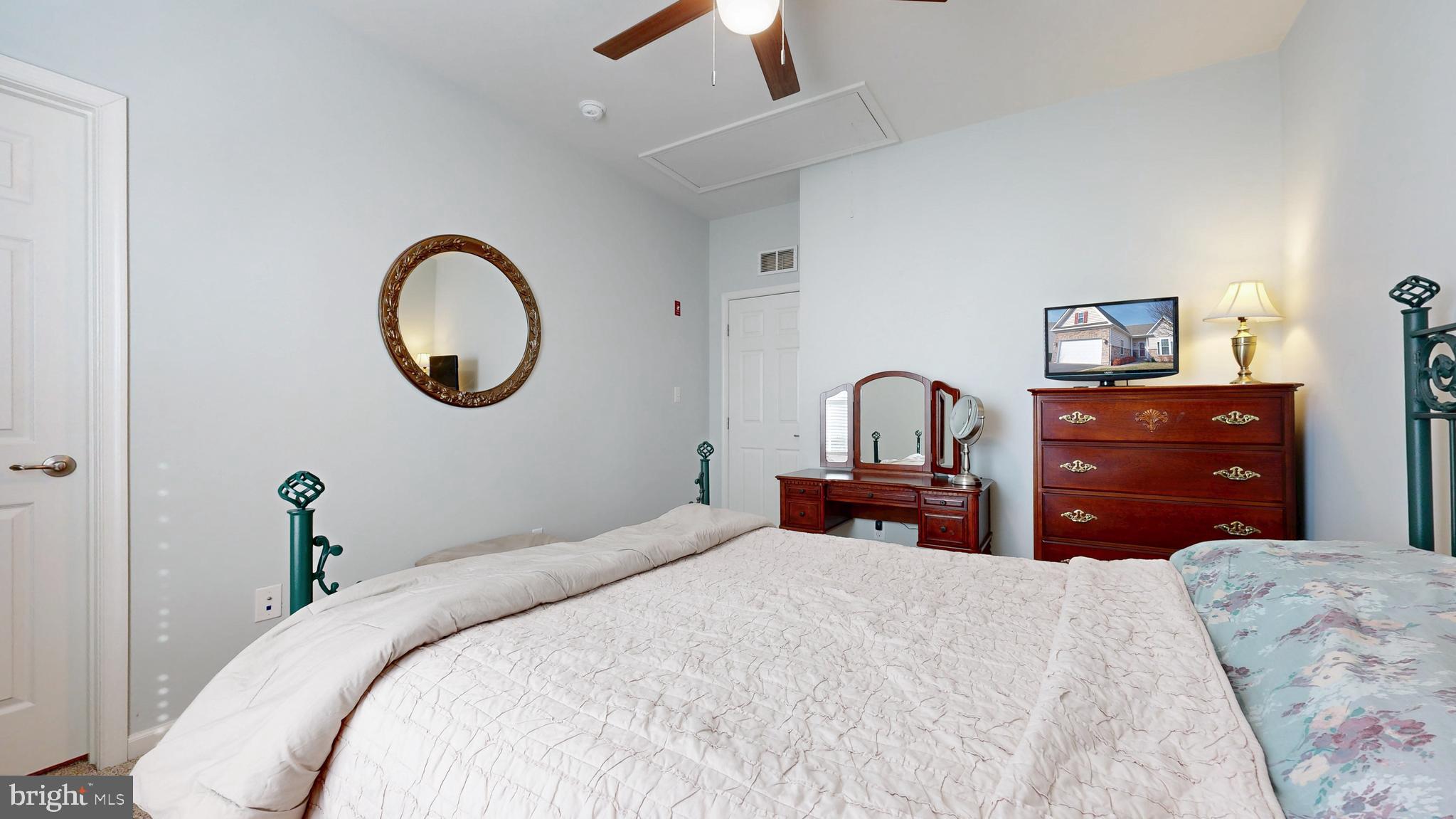 546 Stonehaven Drive Townsend, DE 19734 - Photo 32 of 60 a bedroom with a bed and a chandelier