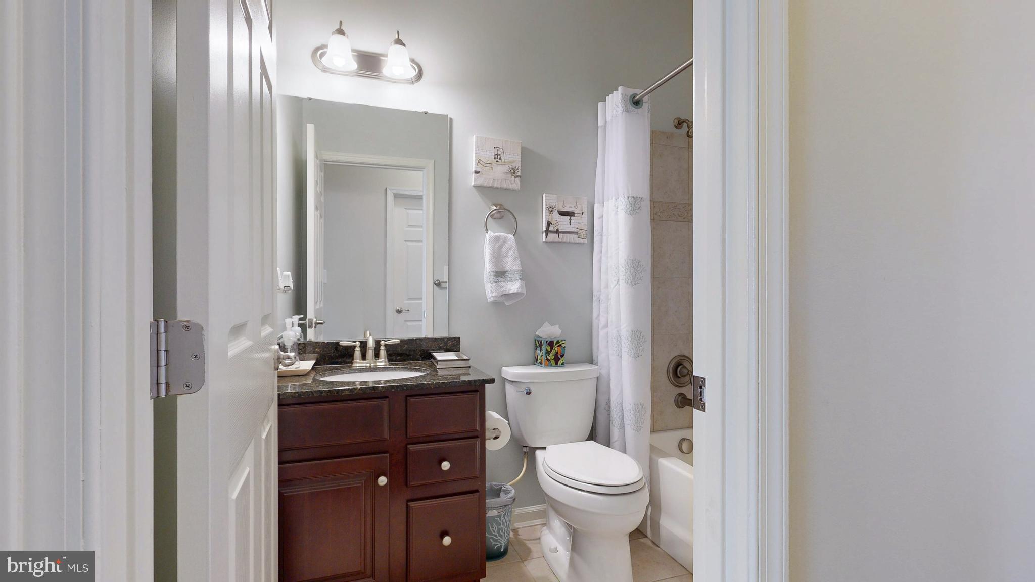 546 Stonehaven Drive Townsend, DE 19734 - Photo 34 of 60 a bathroom with a toilet a sink a mirror a vanity and window